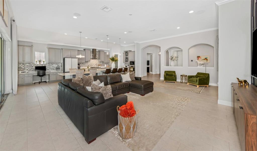 6916 Neopolitan Court Apollo Beach, FL 33572 - Photo 15 of 43 a living room with furniture fireplace and a view of kitchen