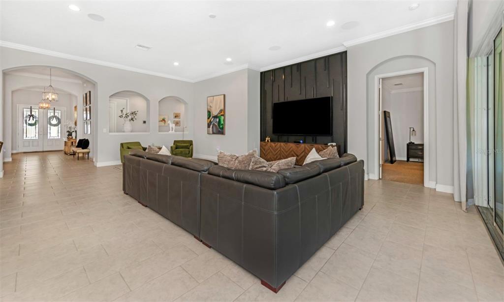 6916 Neopolitan Court Apollo Beach, FL 33572 - Photo 17 of 43 a living room with furniture and a flat screen tv