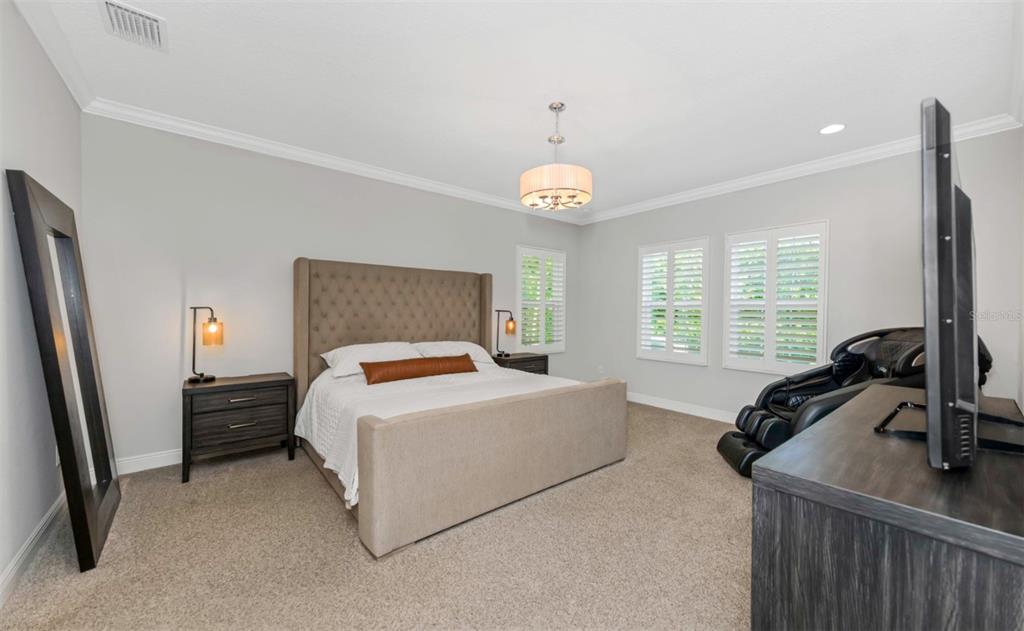 6916 Neopolitan Court Apollo Beach, FL 33572 - Photo 18 of 43 a bed room with a bed window and a dresser