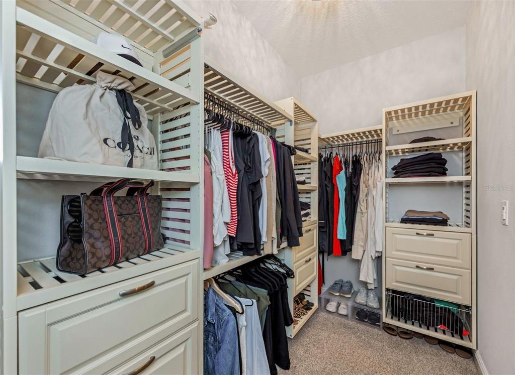 6916 Neopolitan Court Apollo Beach, FL 33572 - Photo 24 of 43 a view of walk in closet with clothes and shoes