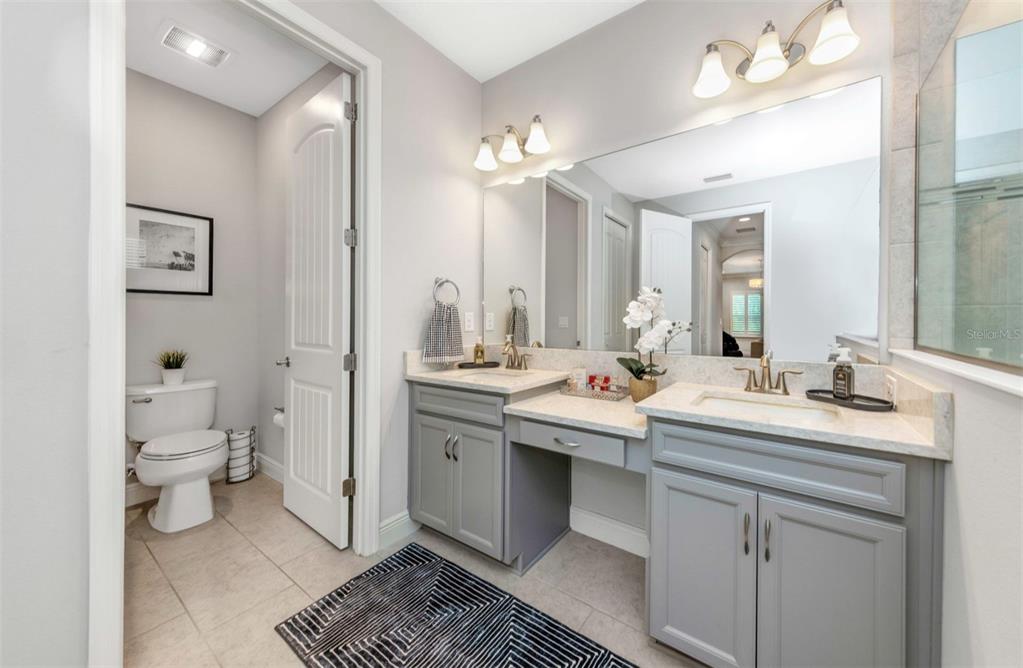 6916 Neopolitan Court Apollo Beach, FL 33572 - Photo 27 of 43 a bathroom with a sink double vanity and a toilet