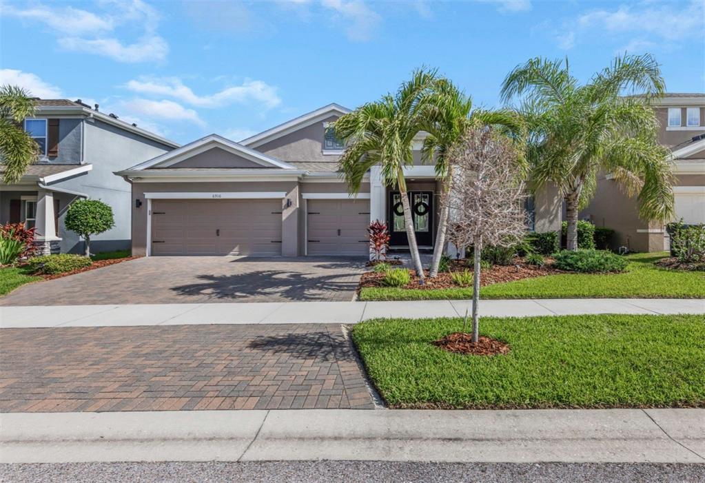 6916 Neopolitan Court Apollo Beach, FL 33572 - Photo 3 of 43 a front view of a house with a yard