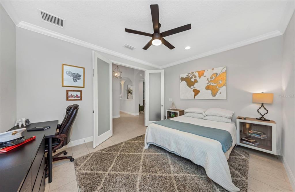 6916 Neopolitan Court Apollo Beach, FL 33572 - Photo 33 of 43 a bedroom with a bed a desk and chair