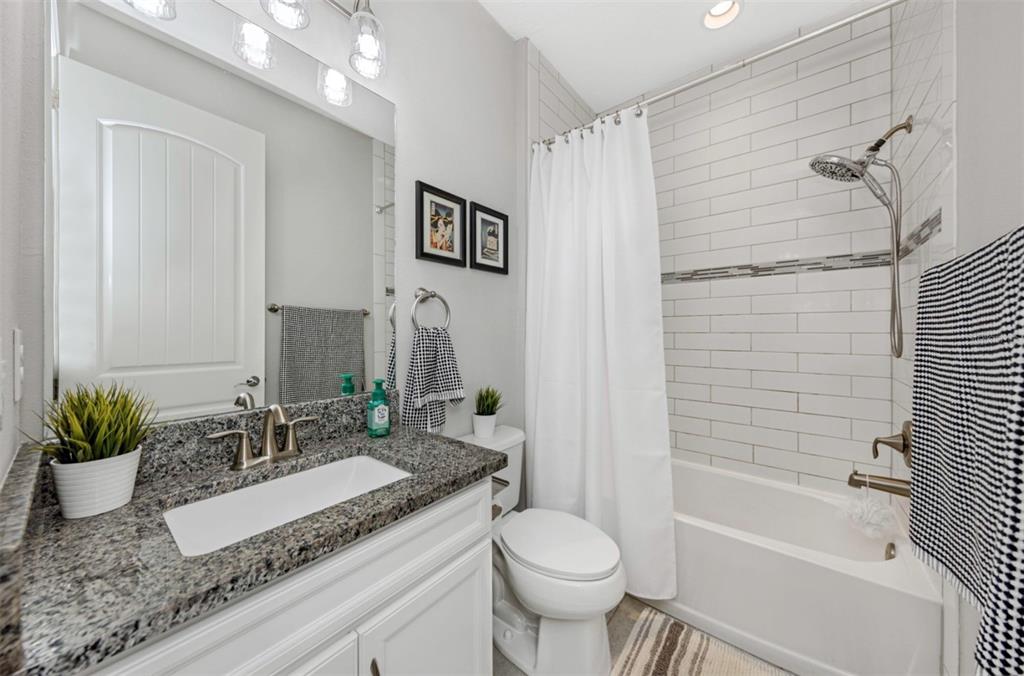 6916 Neopolitan Court Apollo Beach, FL 33572 - Photo 34 of 43 a bathroom with a granite countertop sink a toilet and shower