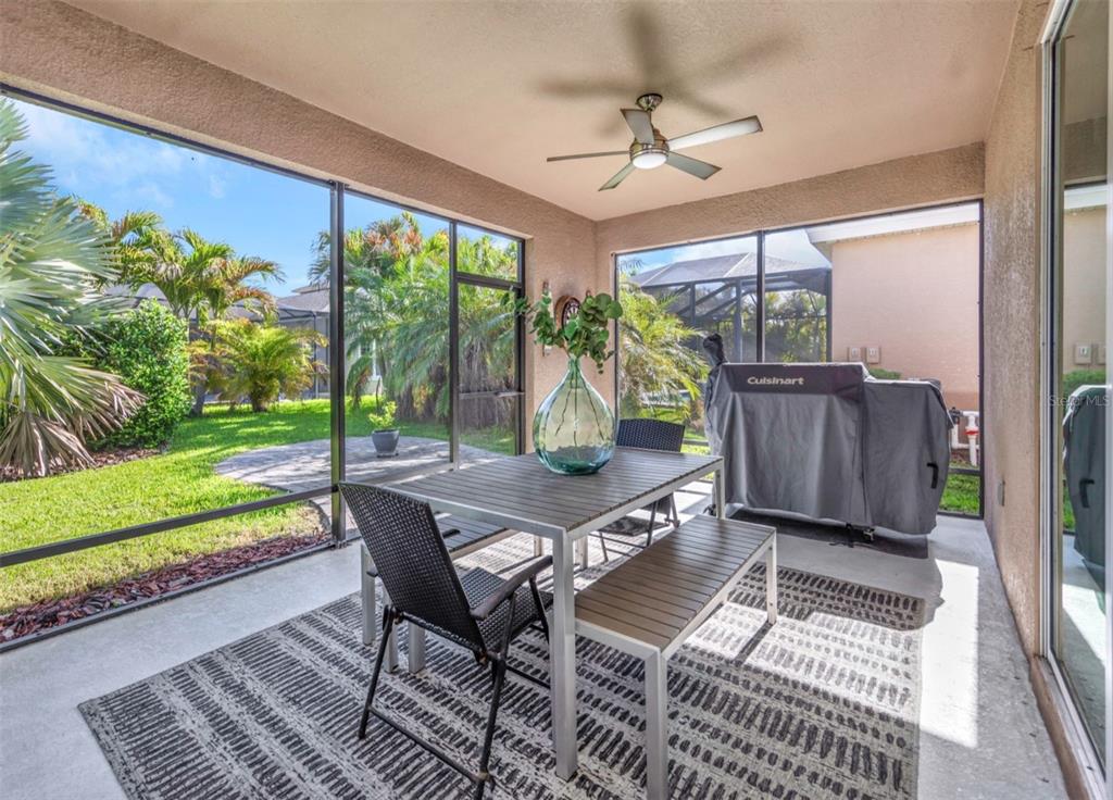 6916 Neopolitan Court Apollo Beach, FL 33572 - Photo 39 of 43 a living room with a floor to ceiling window and a table