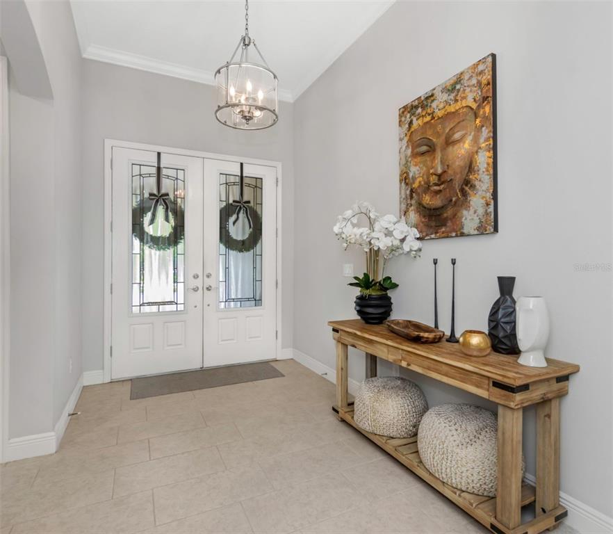 6916 Neopolitan Court Apollo Beach, FL 33572 - Photo 6 of 43 a dining room with furniture and chandelier
