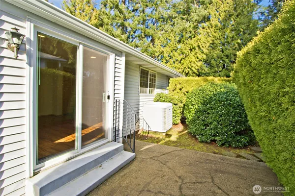 a view of a house with backyard and sitting area