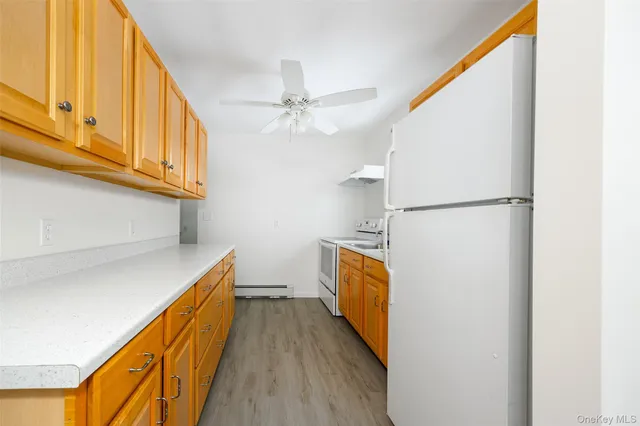a view of a kitchen with wooden floor