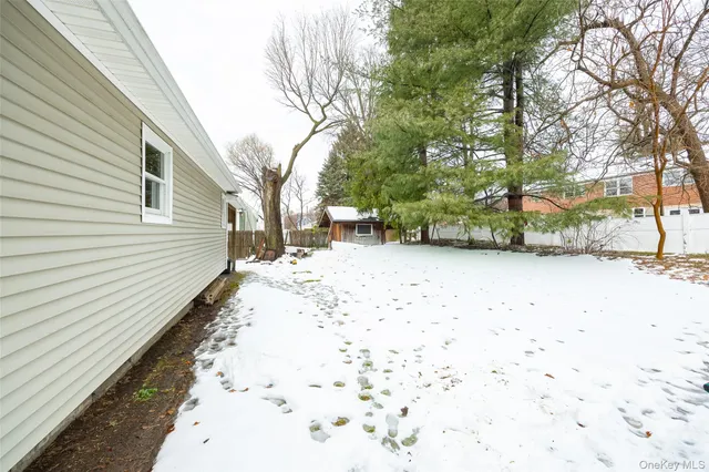 a view of a yard with snow on the road