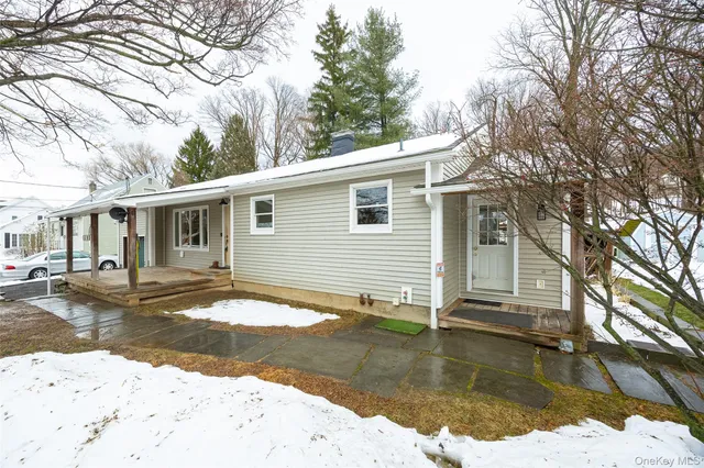 a view of a house with a yard covered in snow