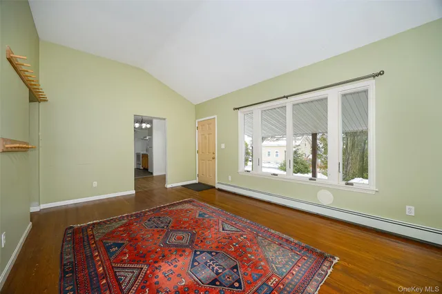 a view of a room with wooden floor and a window