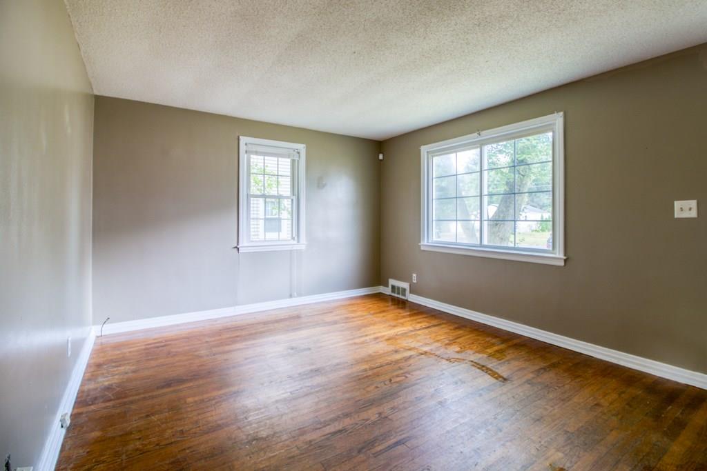 111 Breckwood Boulevard Springfield, MA 01109 - Photo 11 of 25 a view of an empty room with wooden floor and a window