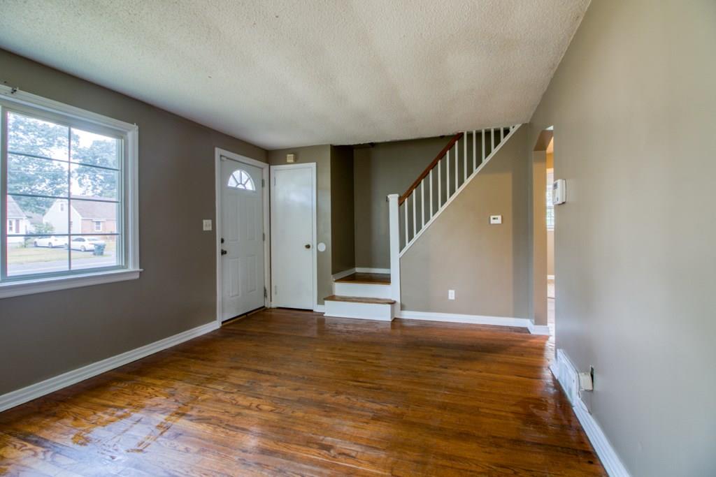 111 Breckwood Boulevard Springfield, MA 01109 - Photo 12 of 25 a view of an empty room with window and wooden floor
