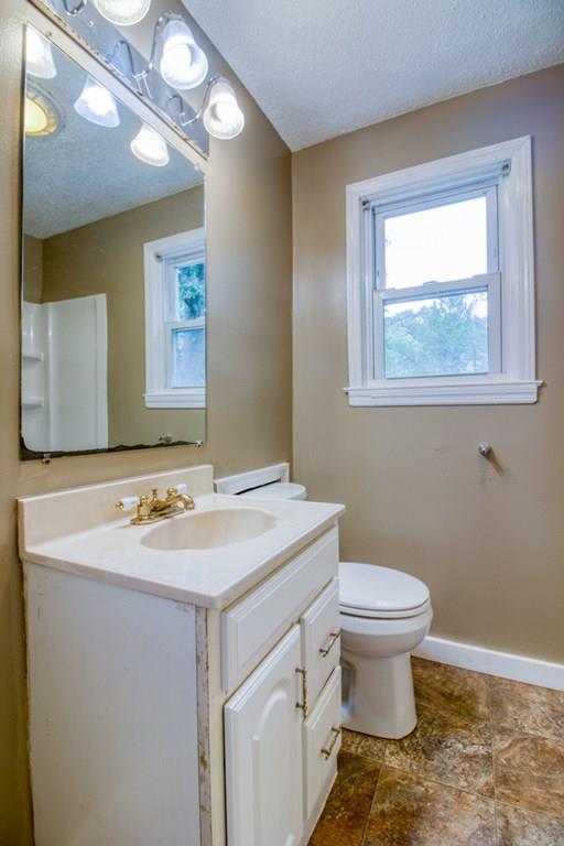 111 Breckwood Boulevard Springfield, MA 01109 - Photo 16 of 25 a bathroom with a sink toilet and mirror