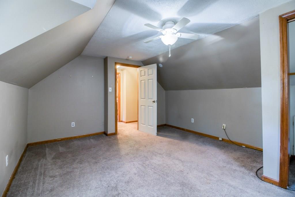 111 Breckwood Boulevard Springfield, MA 01109 - Photo 18 of 25 an empty room with a chandelier fan and windows