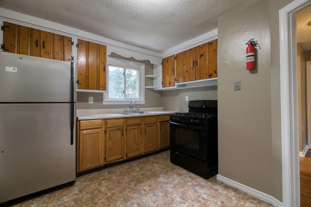 111 Breckwood Boulevard Springfield, MA 01109 - Photo 8 of 25 a kitchen with stainless steel appliances granite countertop a refrigerator and a sink