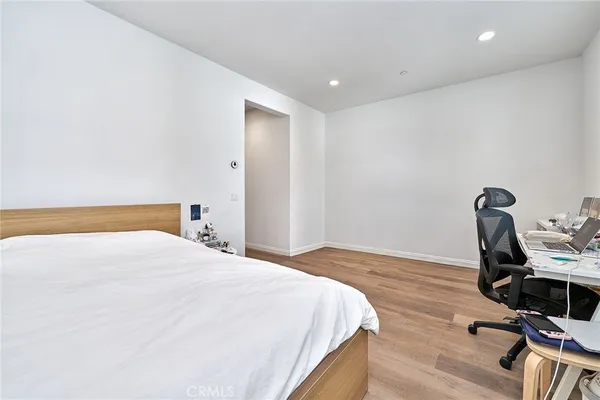 a bedroom with a bed and a desk