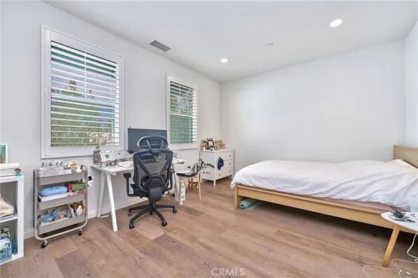 a bedroom with a bed and a chair