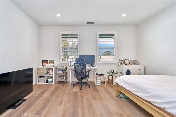 a bedroom with furniture and a flat screen tv