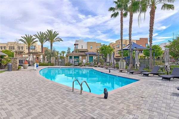 a view of a swimming pool with a lawn chairs and a yard