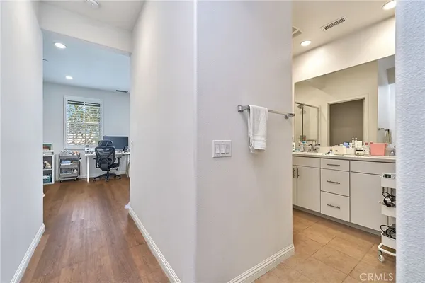 a en suite bathroom with a granite countertop sink and a mirror