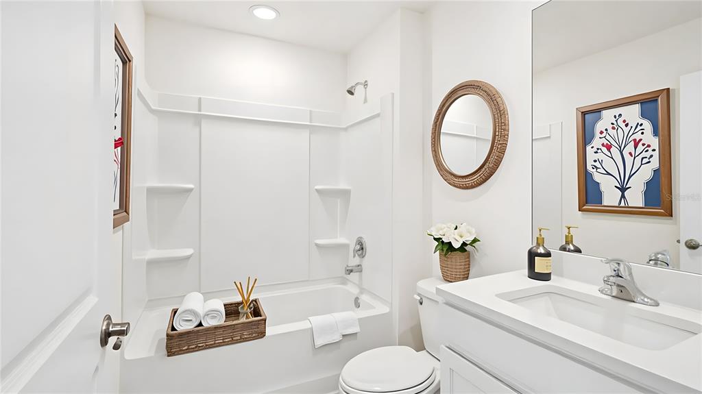 10746 Tucker Road Weeki Wachee, FL 34613 - Photo 6 of 15 a bathroom with a sink a toilet and a mirror