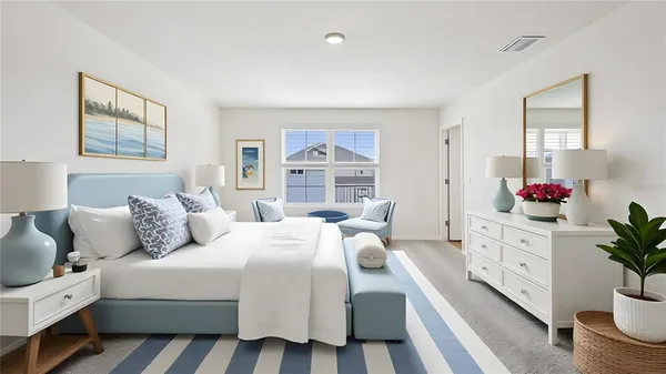 a bedroom with a bed and a potted plant