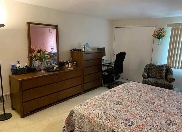 a bedroom with a bed and with furniture