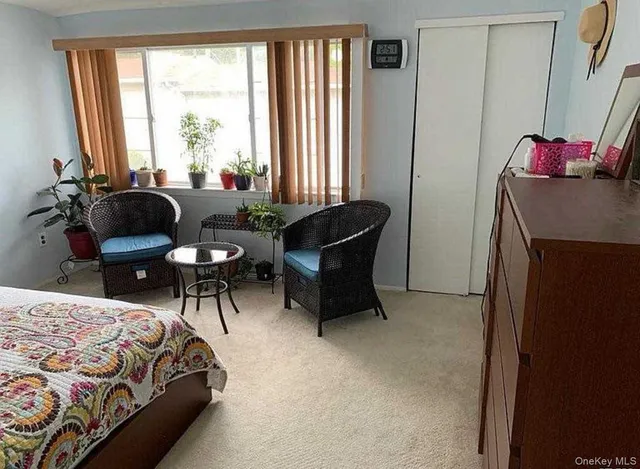 a bedroom with a bed chair and a window