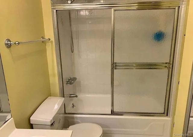 a bathroom with a shower and a toilet