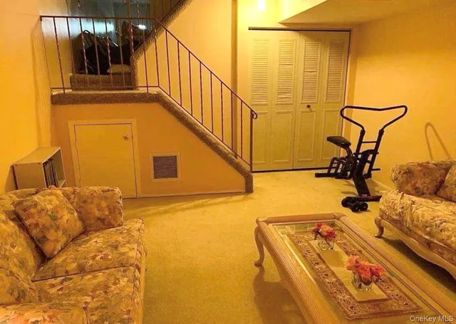 a view of a hall with wooden floor and door