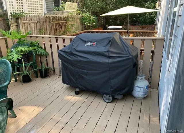 a view of balcony with wooden floor and potted plants
