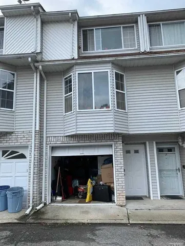a view of a house with a car parked front of it