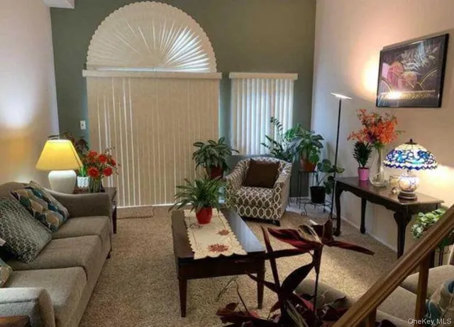 a living room with furniture and a potted plant