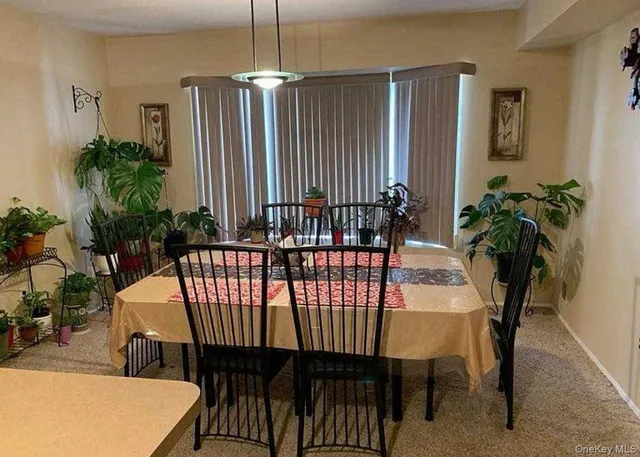 a dining room with furniture and window