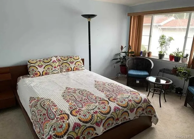 a bedroom with a bed and a table in it