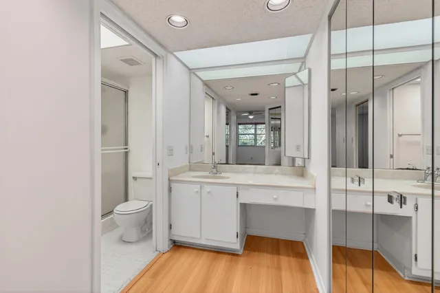 a white toilet and tub sitting next to a bathroom sink