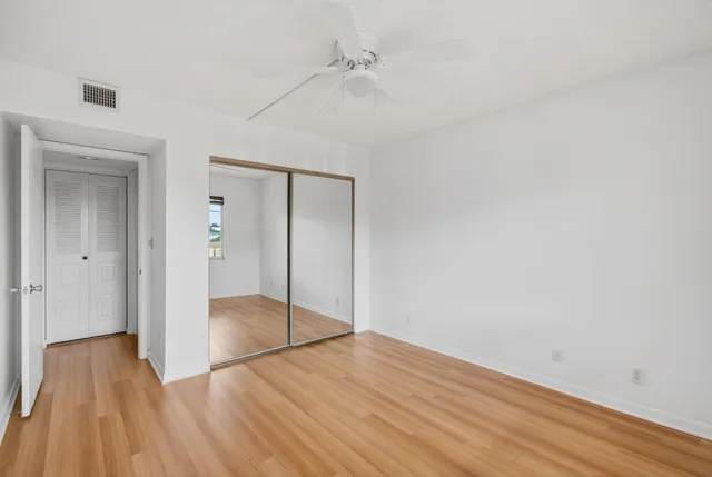 a view of a room with wooden floor and windows