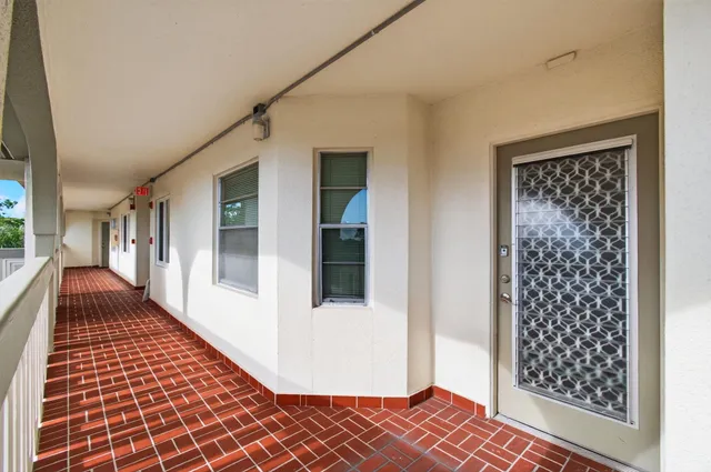 a view of a room with wooden floor and white walls