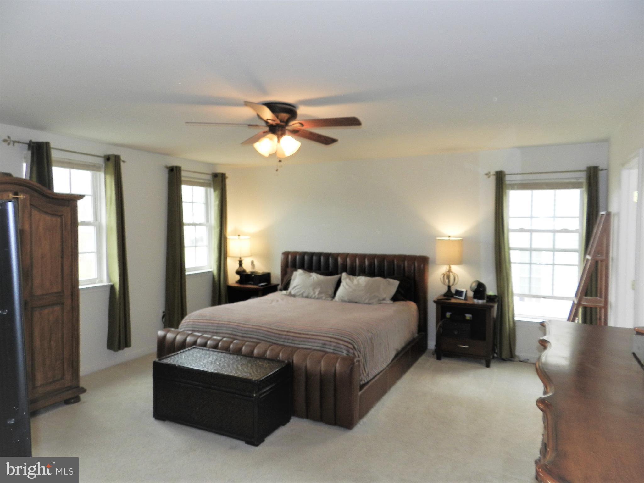 479 Blossom Tree Road Culpeper, VA 22701 - Photo 20 of 30 a bedroom with a bed ceiling fan and a window