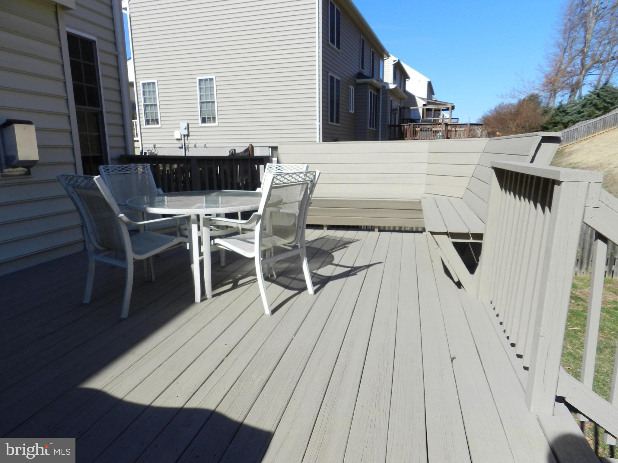 479 Blossom Tree Road Culpeper, VA 22701 - Photo 29 of 30 a view of a roof deck dining table and chairs with wooden floor