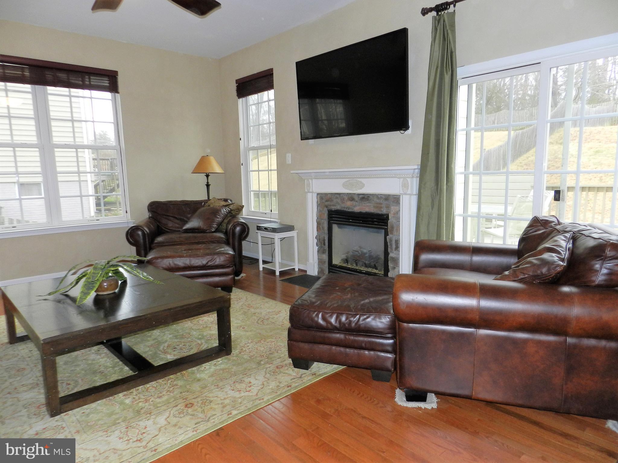 479 Blossom Tree Road Culpeper, VA 22701 - Photo 8 of 30 a living room with furniture a flat screen tv and a fireplace
