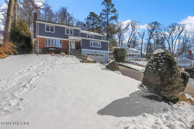 34 Loading Rock Road Riverside, CT 06878 - Photo 1 of 41 a view of a house with a snow in the yard