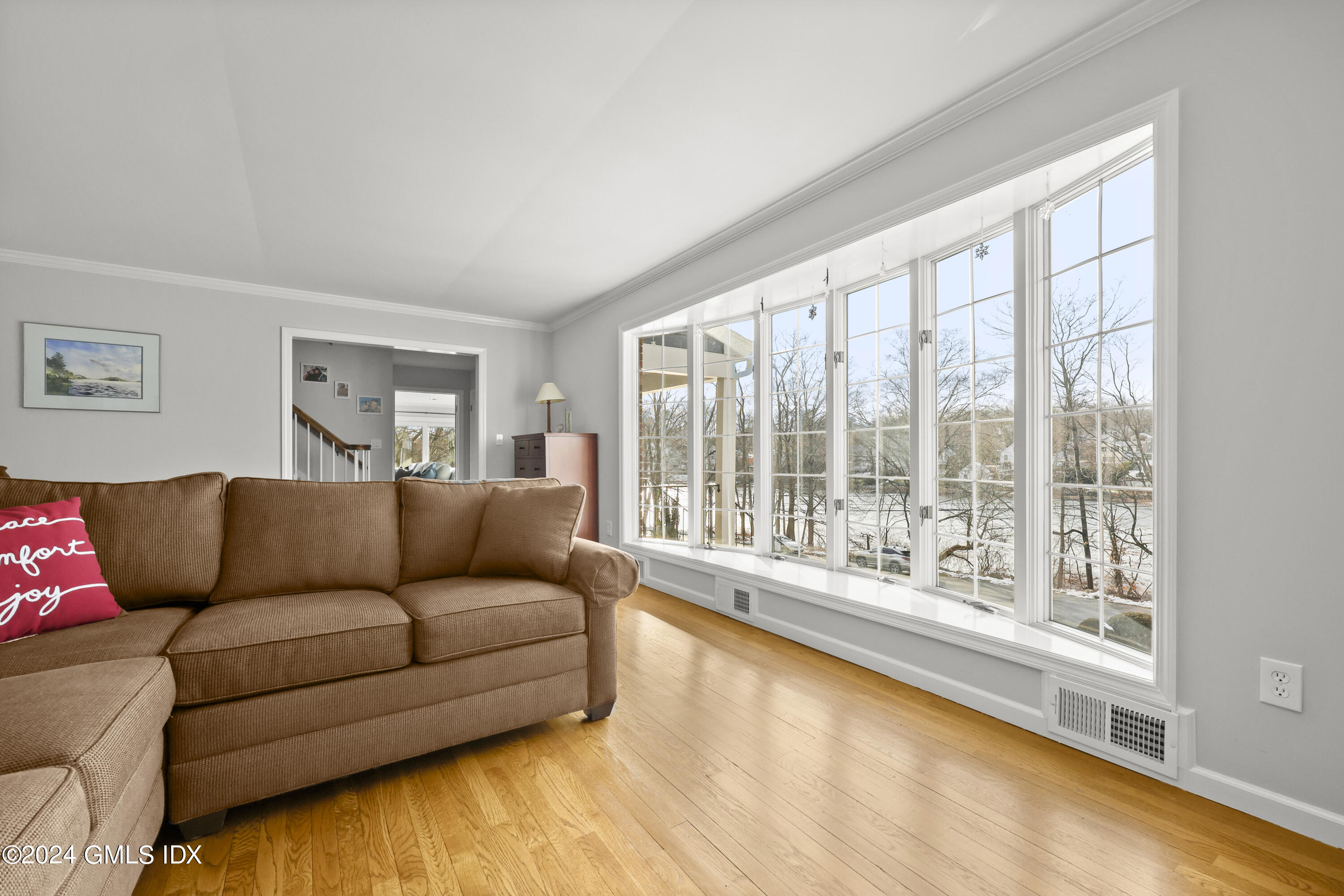 34 Loading Rock Road Riverside, CT 06878 - Photo 13 of 41 a living room with furniture and a large window with outer view