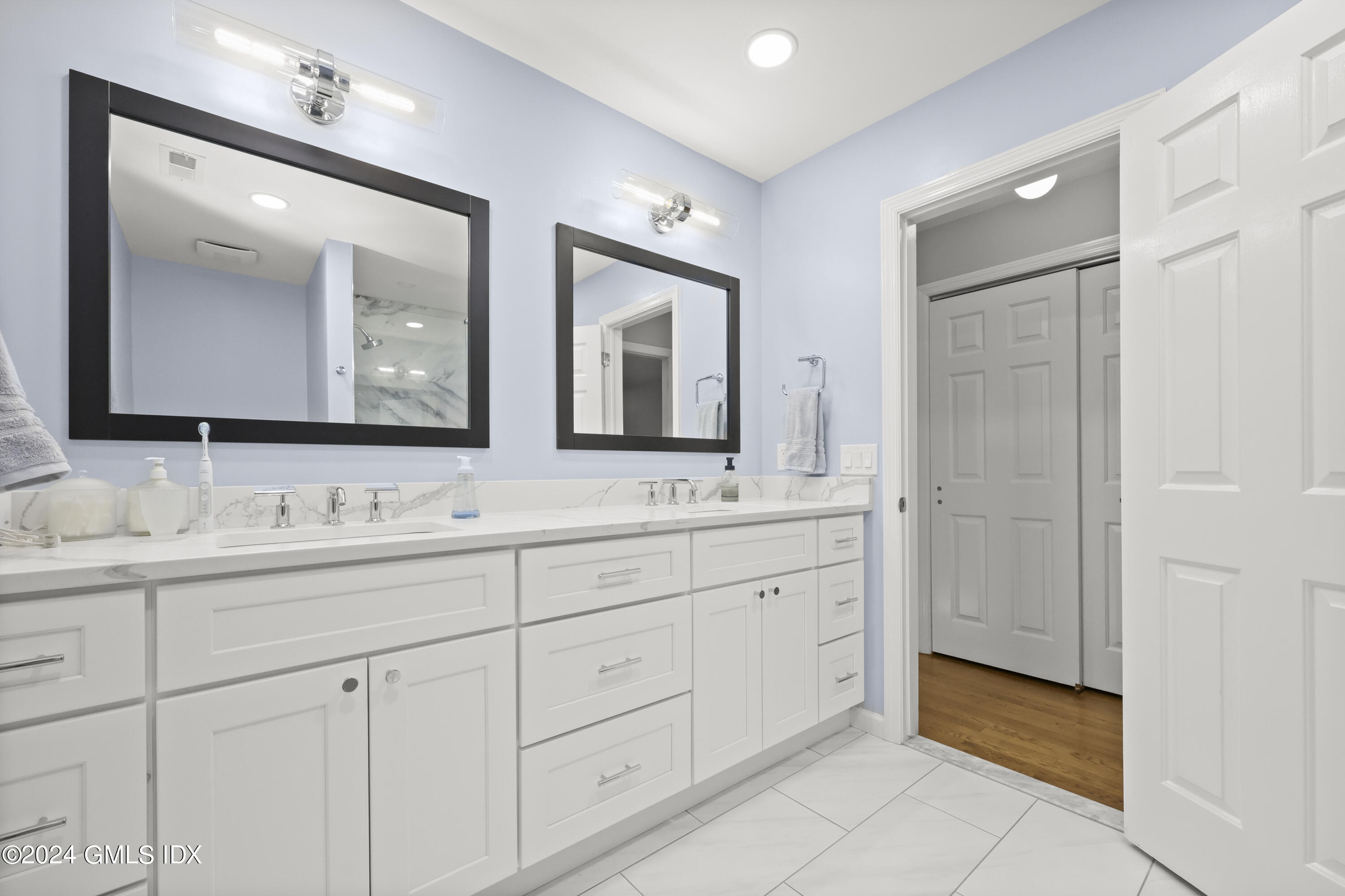 34 Loading Rock Road Riverside, CT 06878 - Photo 17 of 41 a bathroom with double sink and a mirror