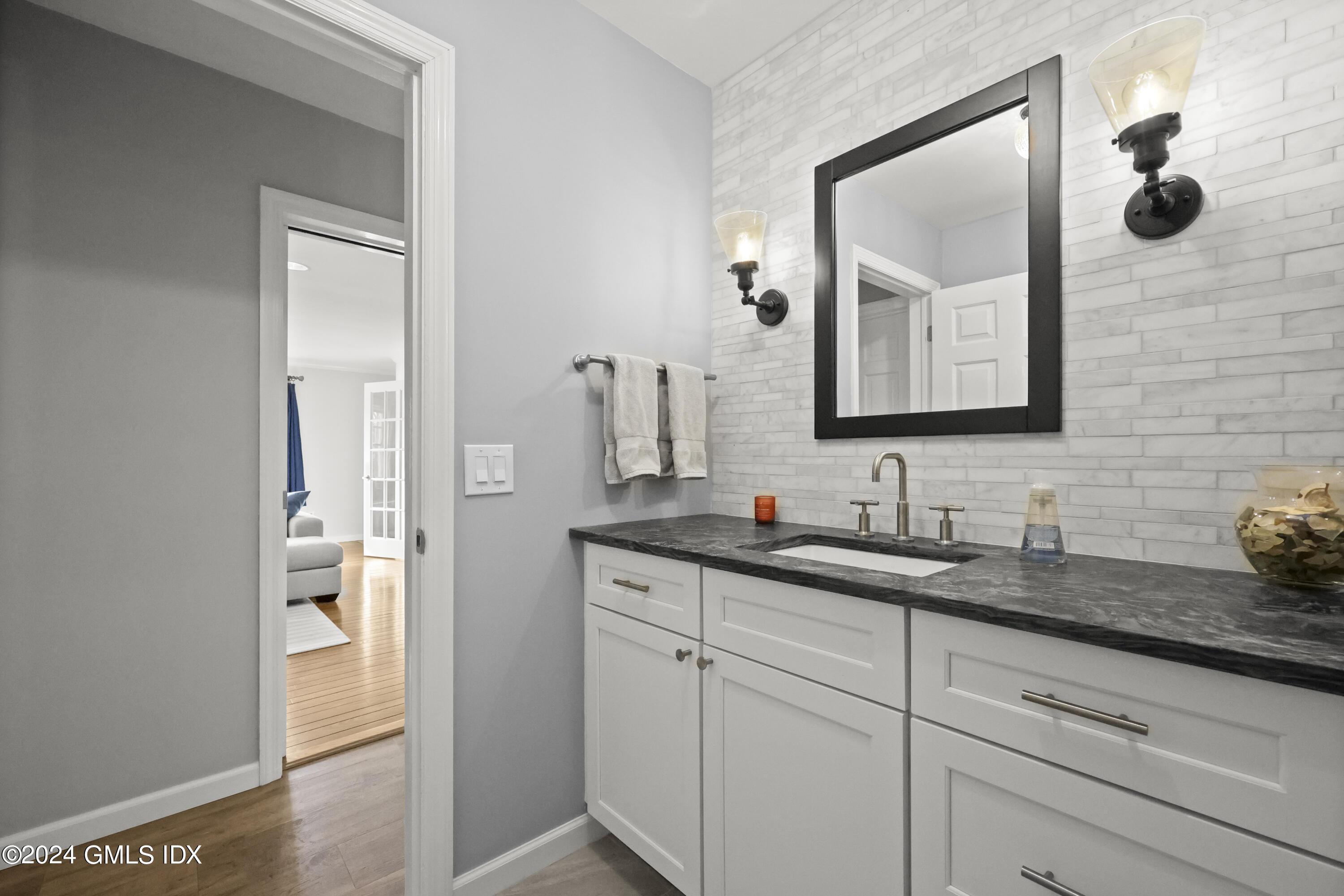 34 Loading Rock Road Riverside, CT 06878 - Photo 28 of 41 a bathroom with a granite countertop sink and a mirror