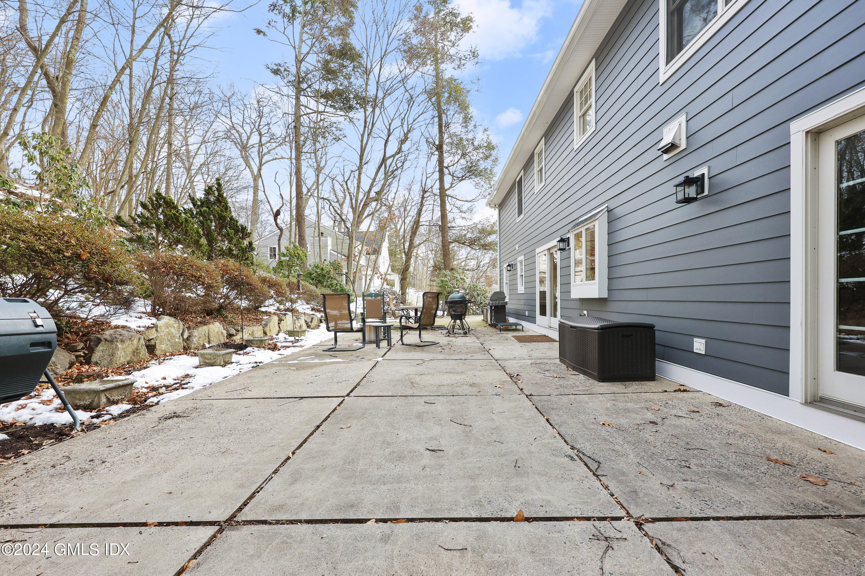 34 Loading Rock Road Riverside, CT 06878 - Photo 38 of 41 a view of a patio with table and chairs with wooden fence and plants