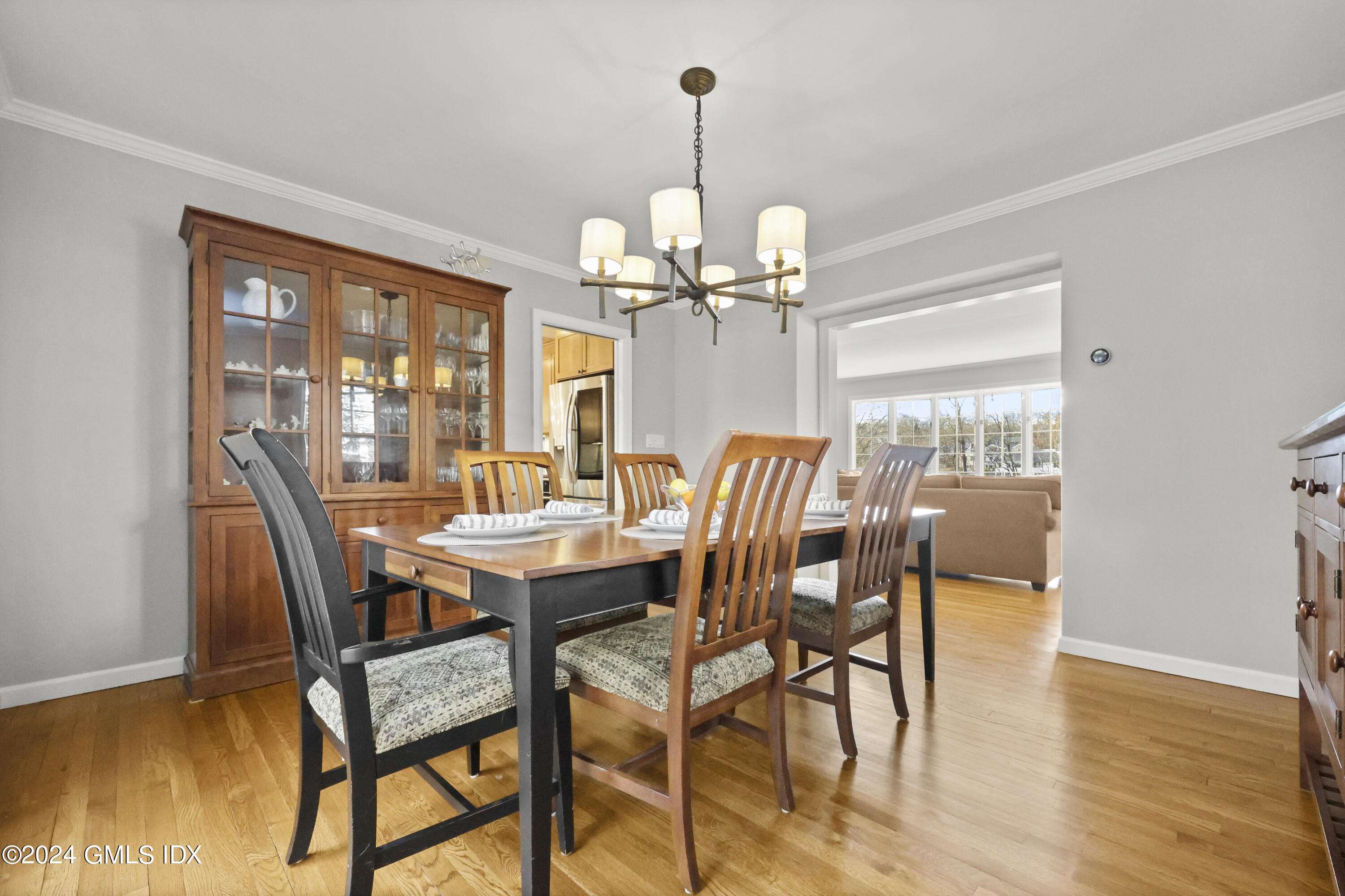 34 Loading Rock Road Riverside, CT 06878 - Photo 7 of 41 a dining room with furniture a chandelier and wooden floor