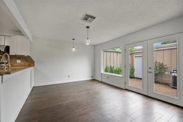 a view of an empty room with windows