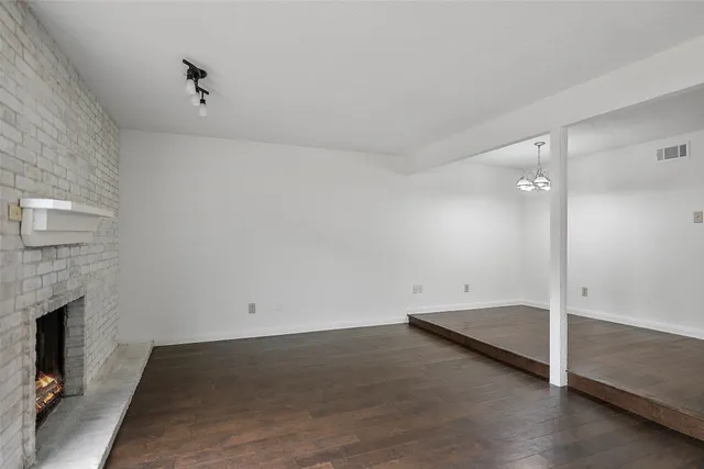 wooden floor in an empty room with a fireplace